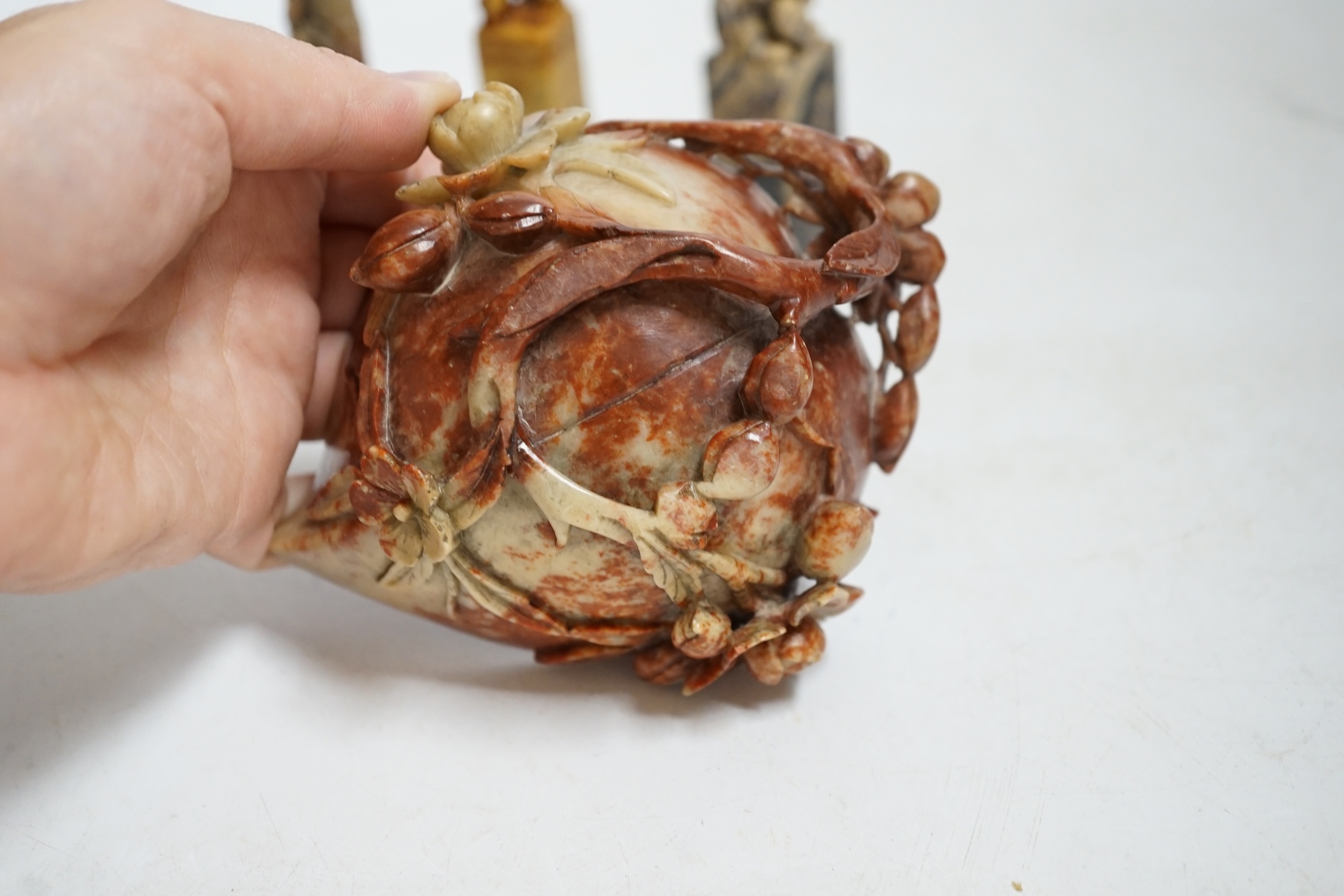 Three Chinese carved soapstone seals and a 'peach' cup, largest 12.5cm wide. Condition - fair to good